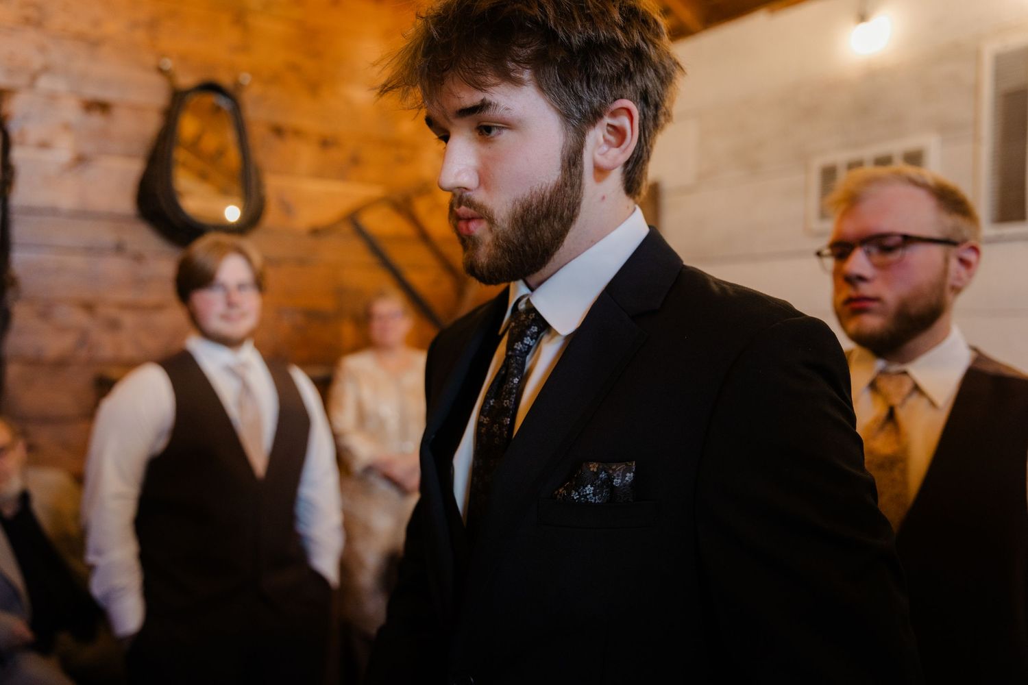 People gathered in a rustic brick-walled venue with warm lighting for a social event.