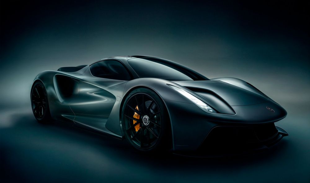 Sleek dark green concept supercar with aggressive aerodynamic design, yellow brake calipers, and low-profile stance on studio background.