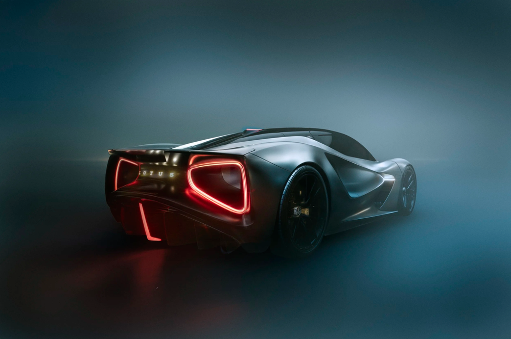 A sleek futuristic sports car with glowing red LED taillights photographed in dramatic low-light conditions.