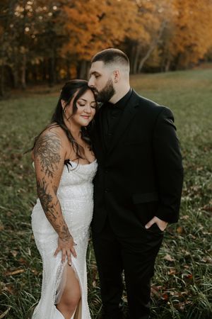 Artistic wedding portraits captured in a natural setting with autumn colors and tall grass.