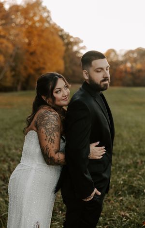 Candid wedding moments photographed in a rustic outdoor setting during fall season.