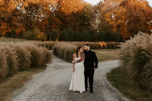 A romantic walk on a gravel path with fall foliage and ornamental grasses.