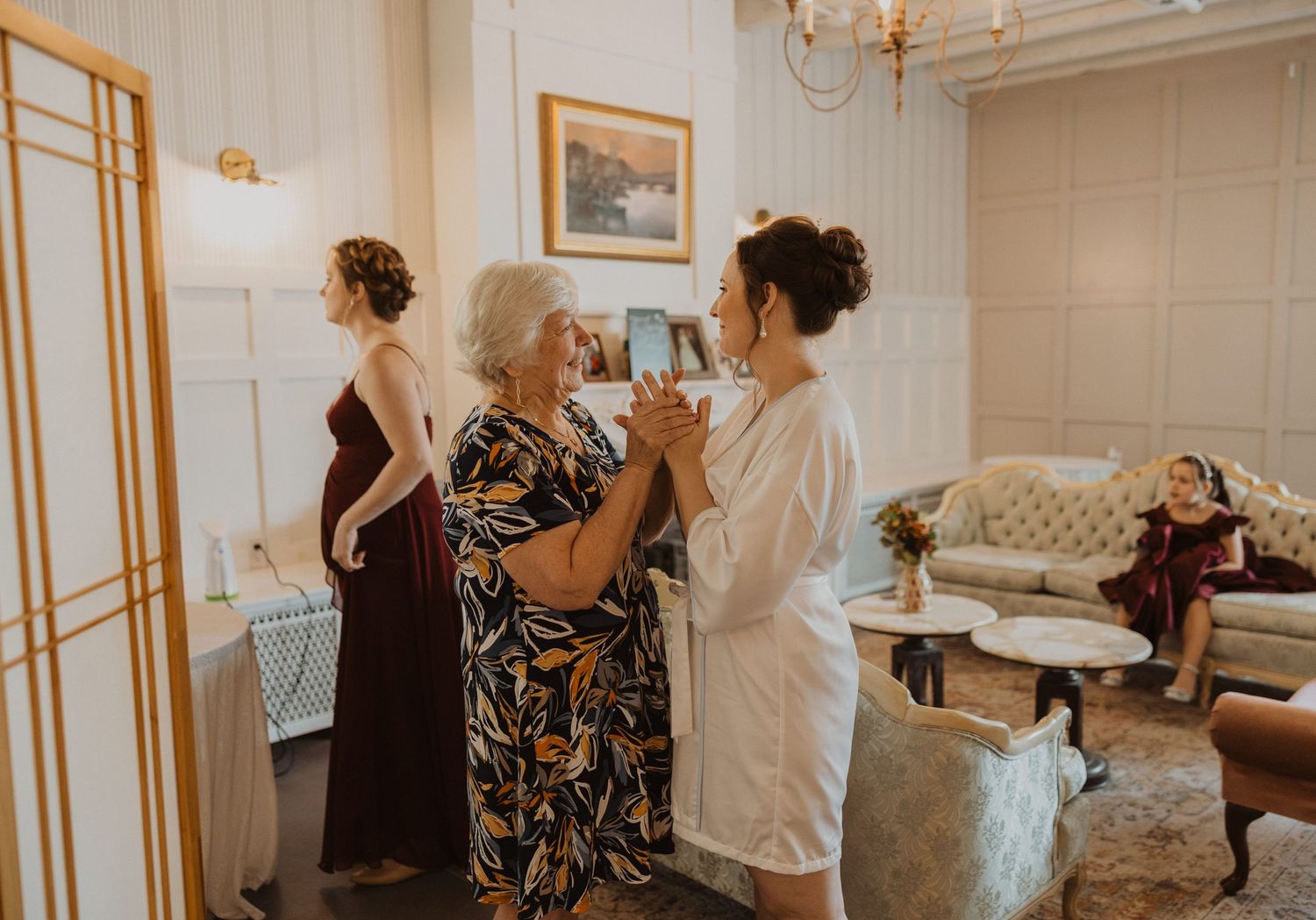 Getting ready scene in bridal suite with elegant decor and vintage furniture.
