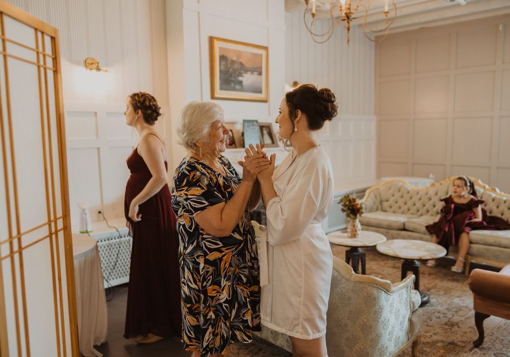 Getting ready scene in bridal suite with elegant decor and vintage furniture.