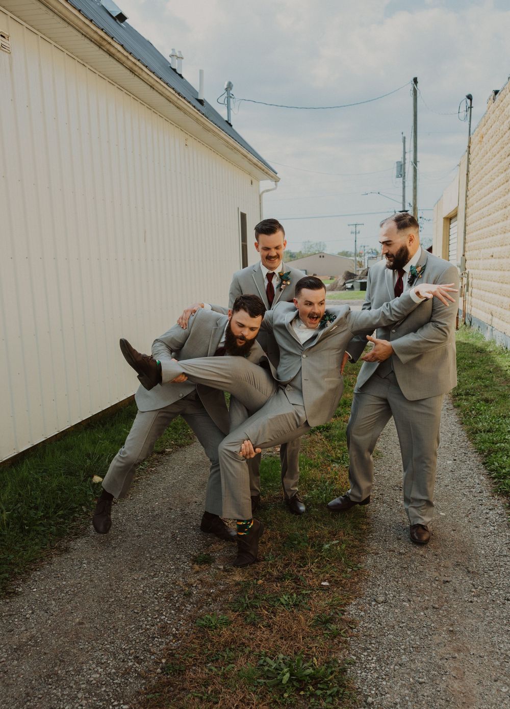Groomsmen perform synchronized kicking poses in a fun wedding photo shoot.