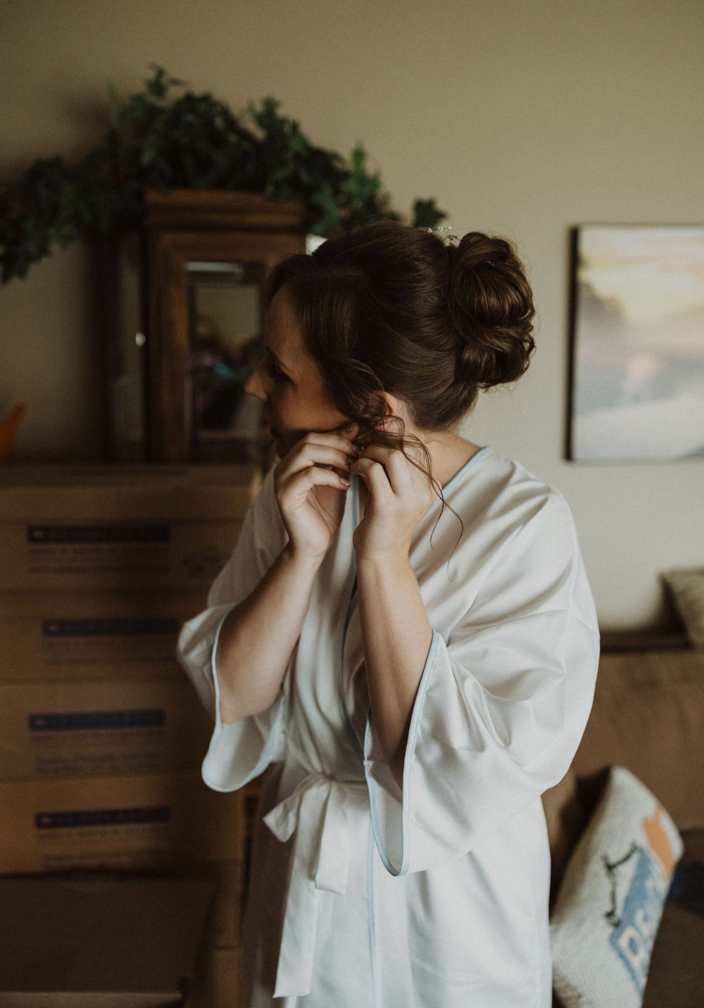 Person in white robe getting ready in morning light.