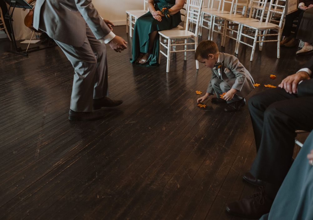 Dark hardwood floors contrast with white walls in an elegant wedding venue setting.
