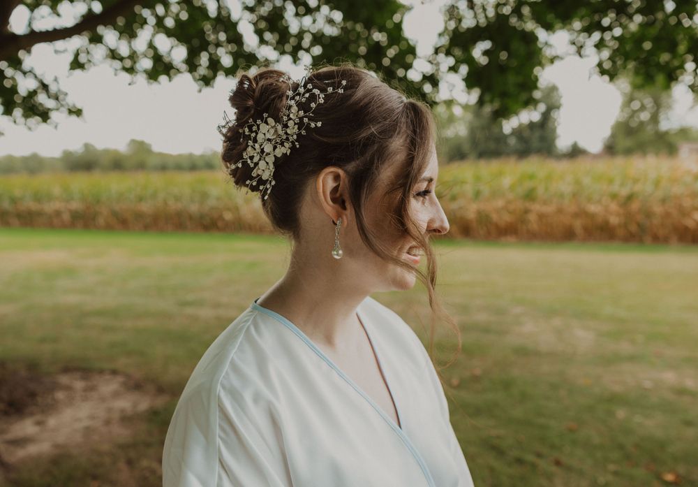 Side profile wedding portrait with soft natural lighting outdoors.