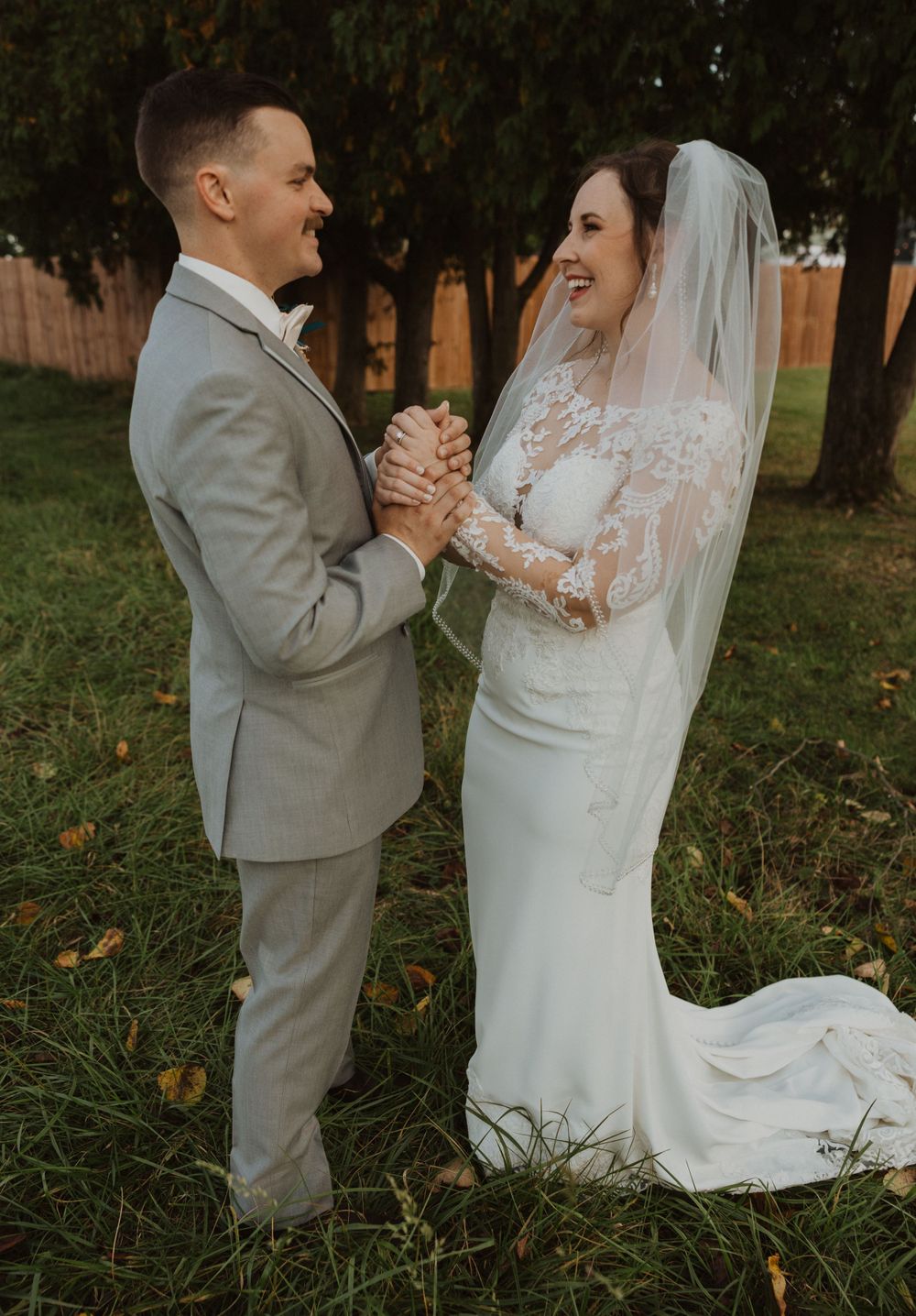 Candid wedding moments photographed in a park setting with lush greenery and natural lighting.