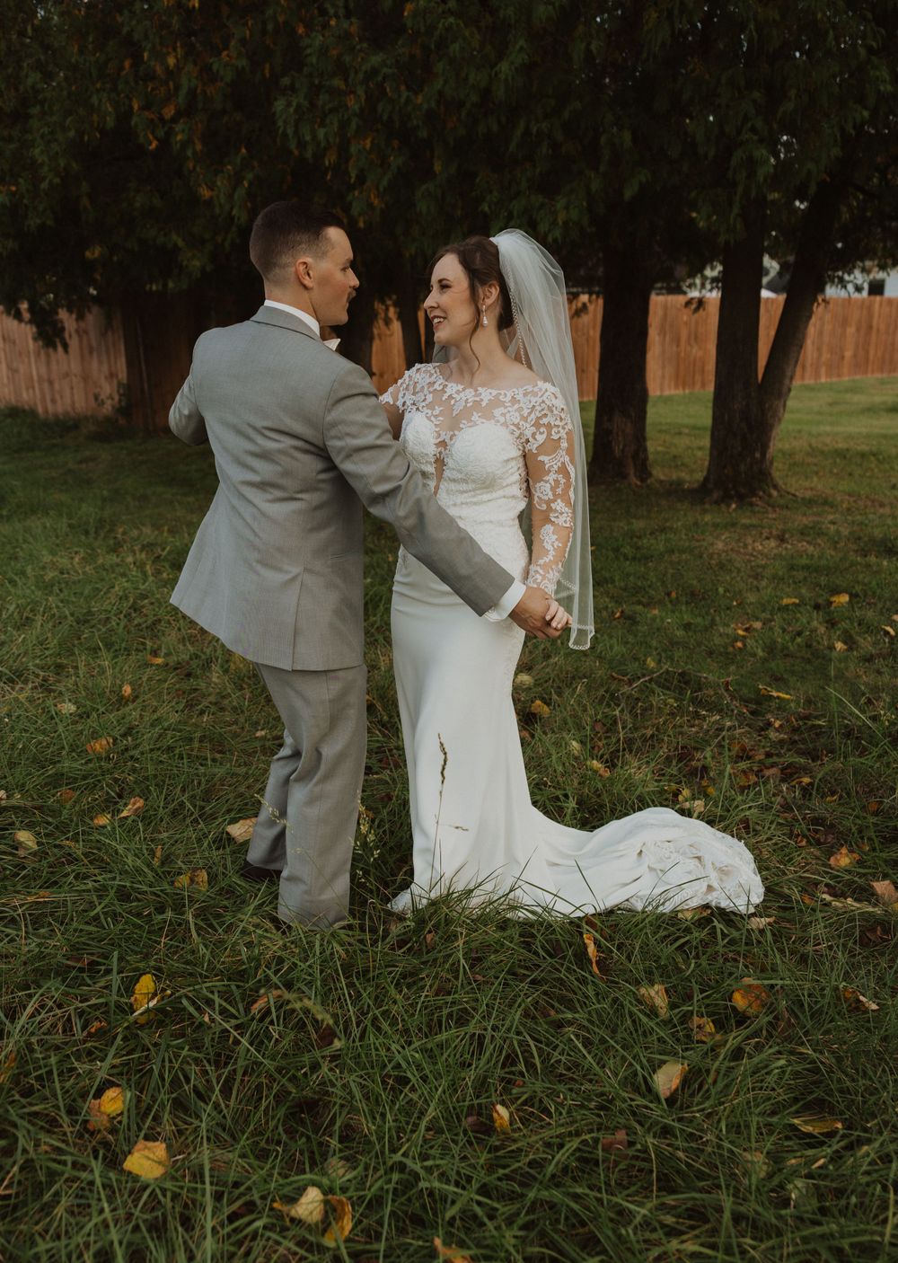 Romantic wedding photography session in an outdoor garden with evening light.