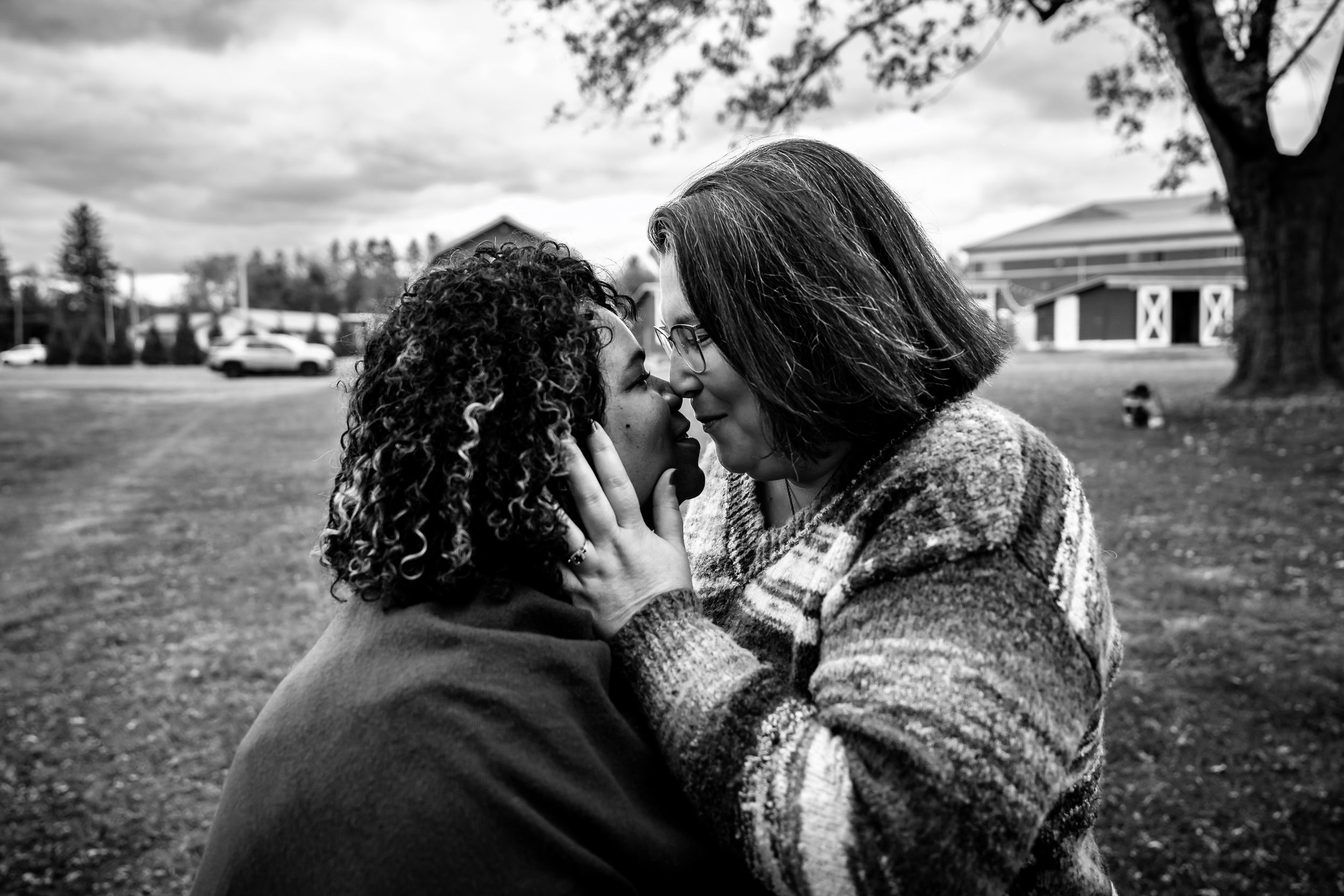 A romantic black and white photo series showing a couple sharing intimate moments in nature.