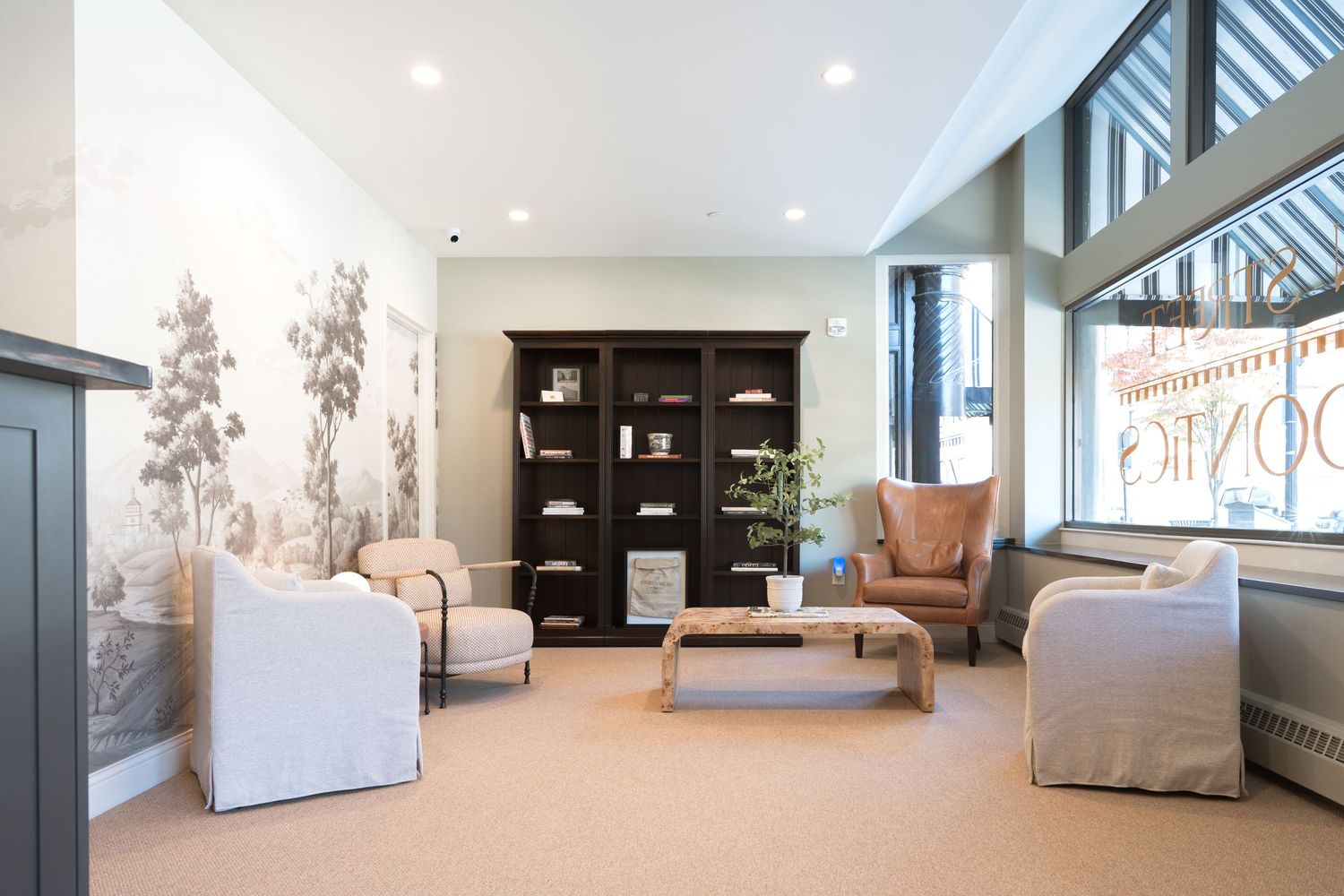 Modern medical office interior with clean white walls, recessed lighting, and contemporary furniture.