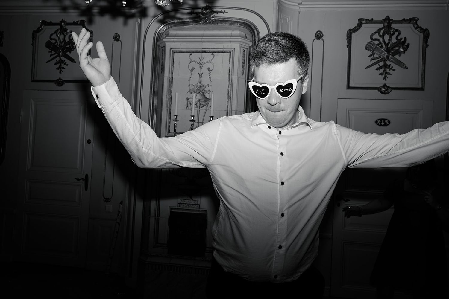 Black and white photo series showing a person in a white shirt dancing and moving expressively against a dark wall.