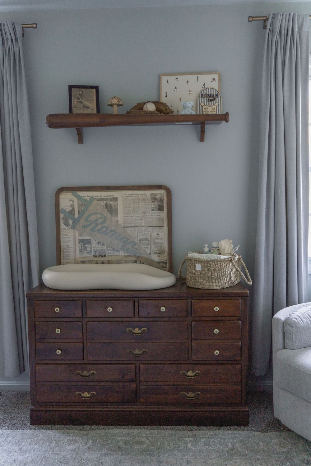 Three matching dark wood dressers with brass hardware arranged along a light gray wall with white curtains in Macedonia, Ohio newborn photos