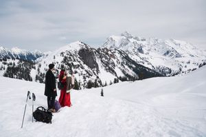 Snow-covered mountain peaks rise majestically against a winter sky in a scenic alpine landscape.