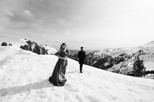 A panoramic sequence of winter mountain slopes covered in pristine snow with skiers carving tracks down the terrain.