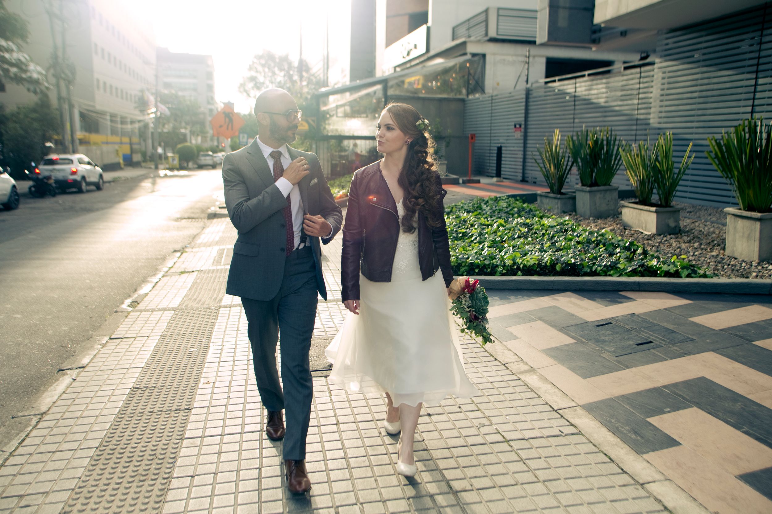 A newly married couple walks through the streets.