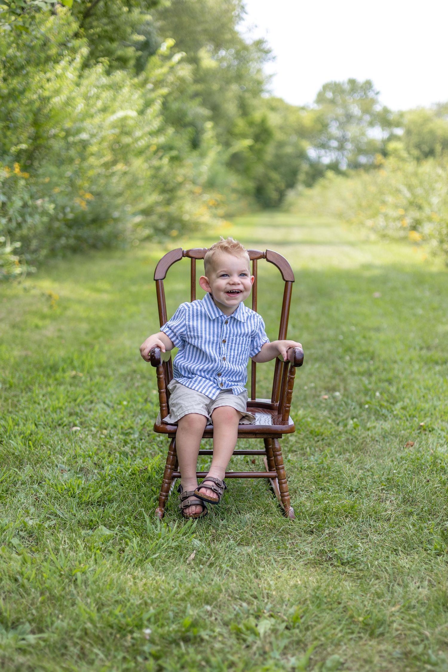 Springfield, IL Photographer captures a boy smiling on a chair during a milestone session in Central, IL