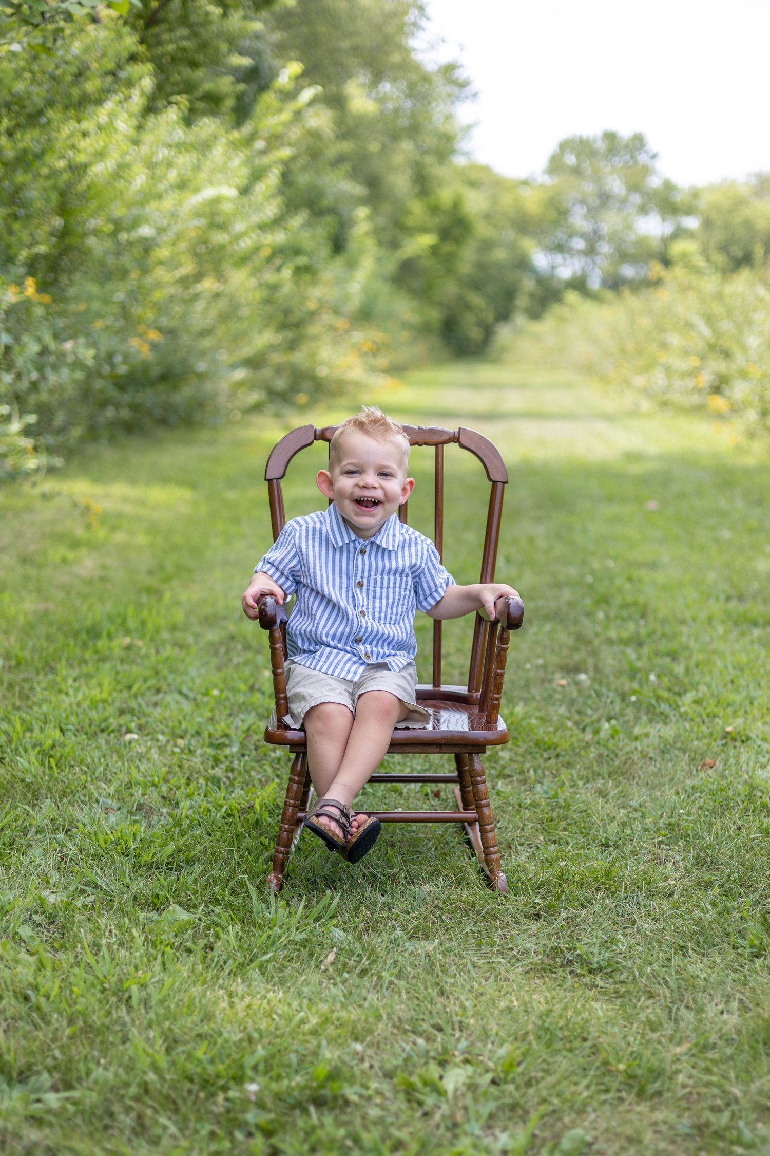 Springfield, IL Photographer captures a boy smiling on a chair during a milestone session in Central, IL
