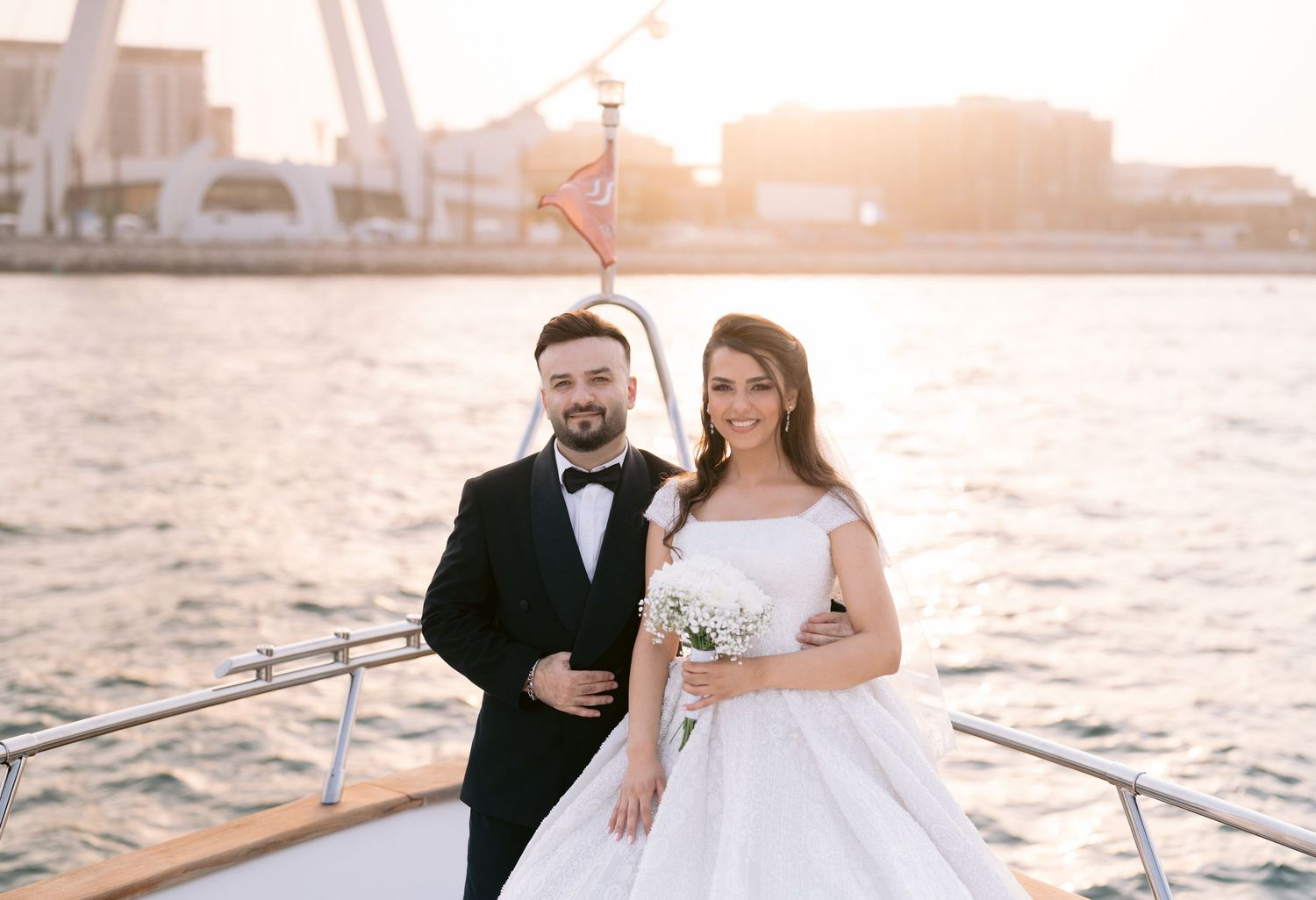A series of happily married couple portraits taken by the water during sunset at a seaside venue.