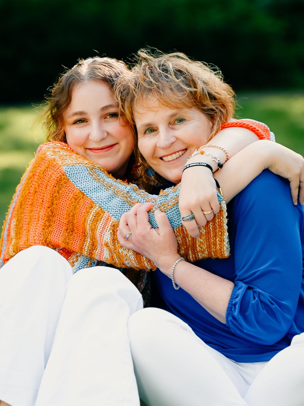 Close up candid shots showing affectionate embrace with people wearing orange and blue.