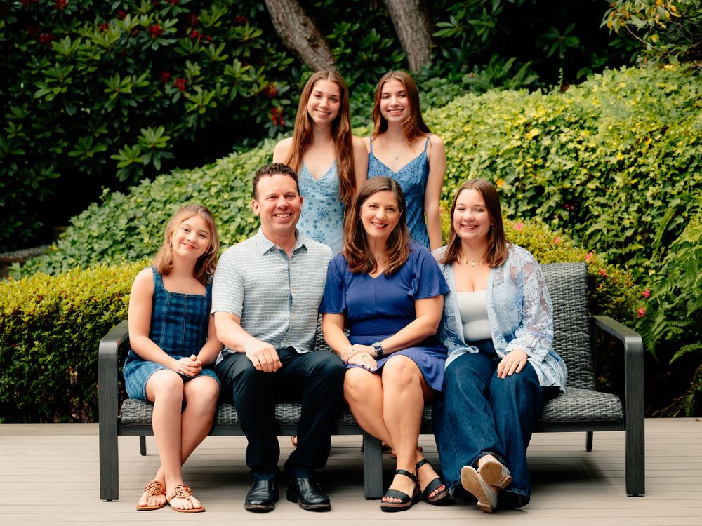 A collage of family portraits showing people sitting together on outdoor benches in a garden setting.