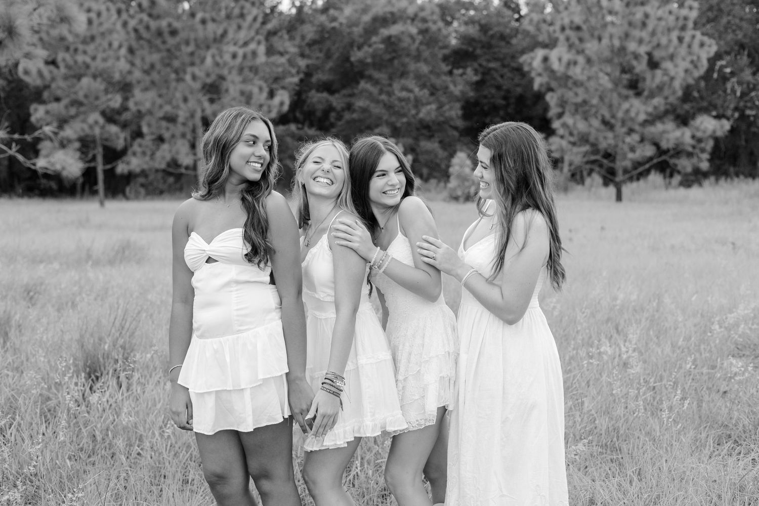 Black and white photo of a group celebrating together in a natural outdoor setting.