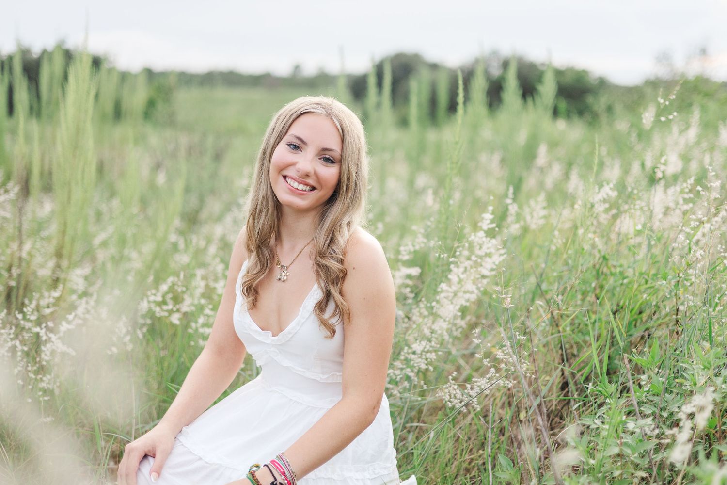 Candid outdoor portraits in a sunny wildflower field.