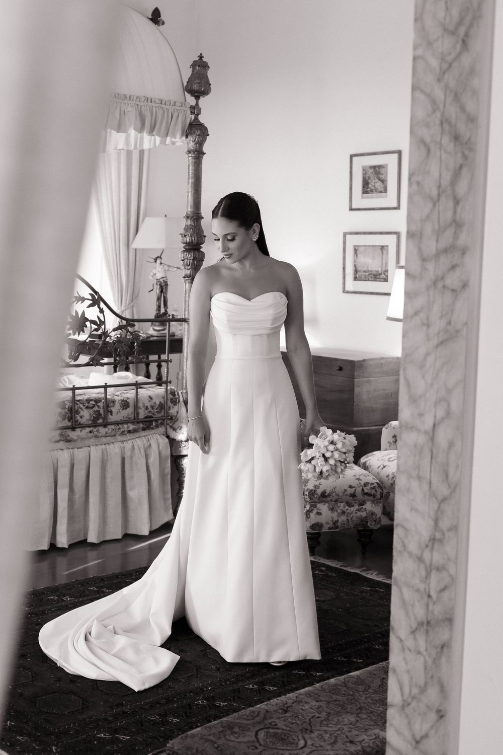 A black and white photo series of a wedding dress displayed in different angles in an elegant vintage interior space.