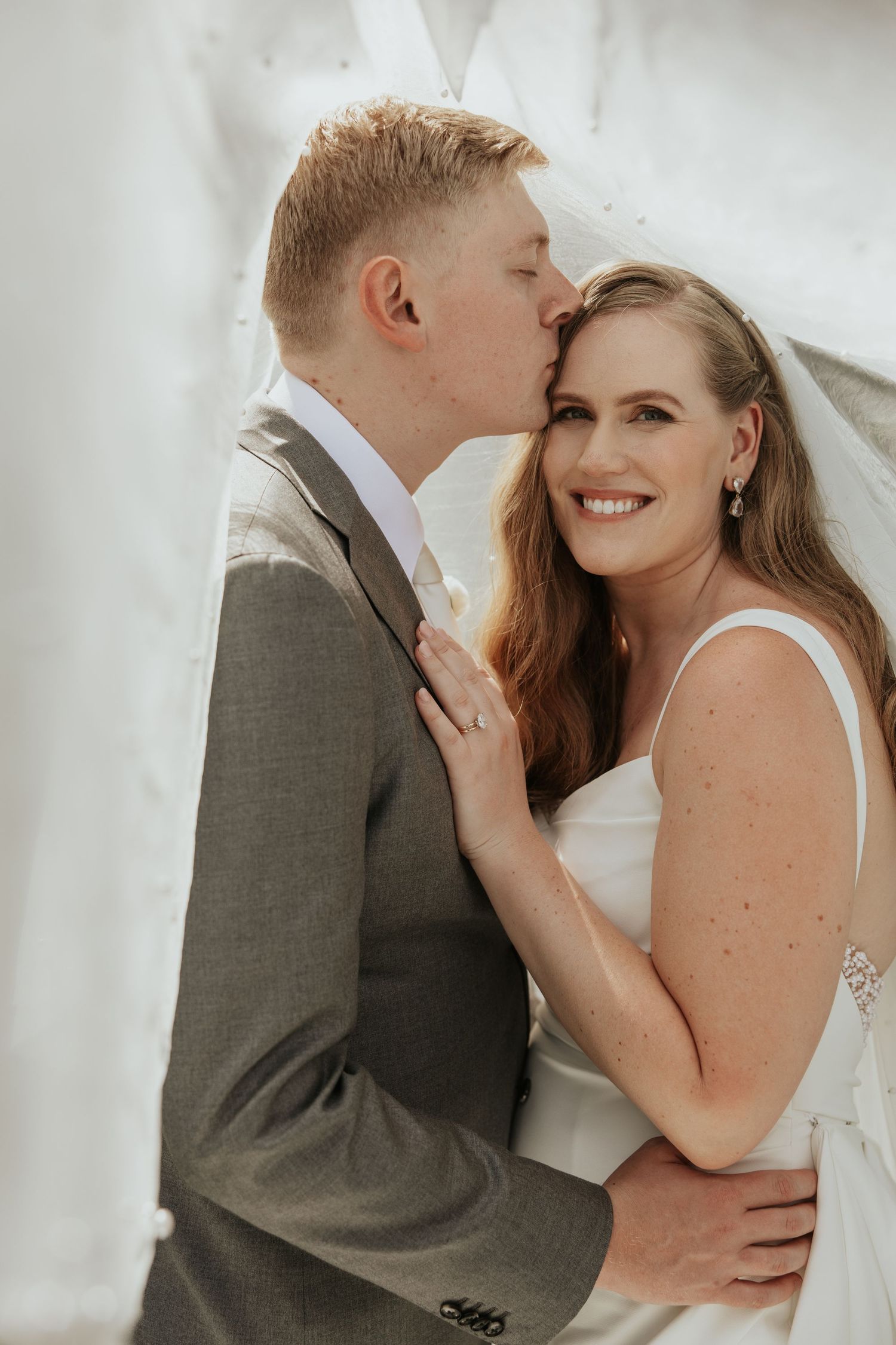 A romantic wedding photography sequence showing tender moments between a couple in gray suit and white dress against light background.