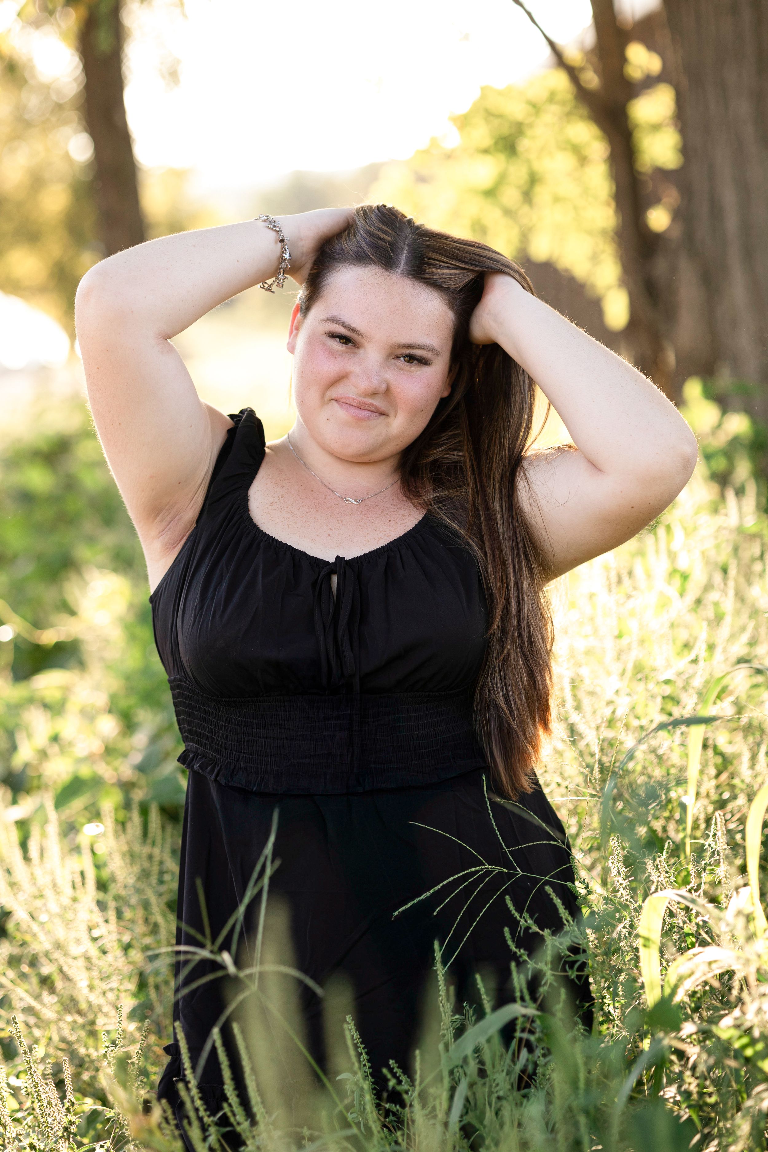 A series of outdoor portrait shots in tall grass with warm sunlight filtering through trees in the background.