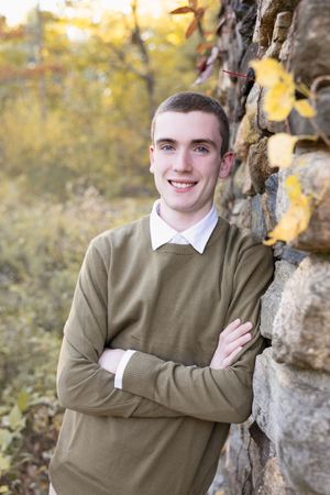 Portrait series against autumn backdrop with stone wall.