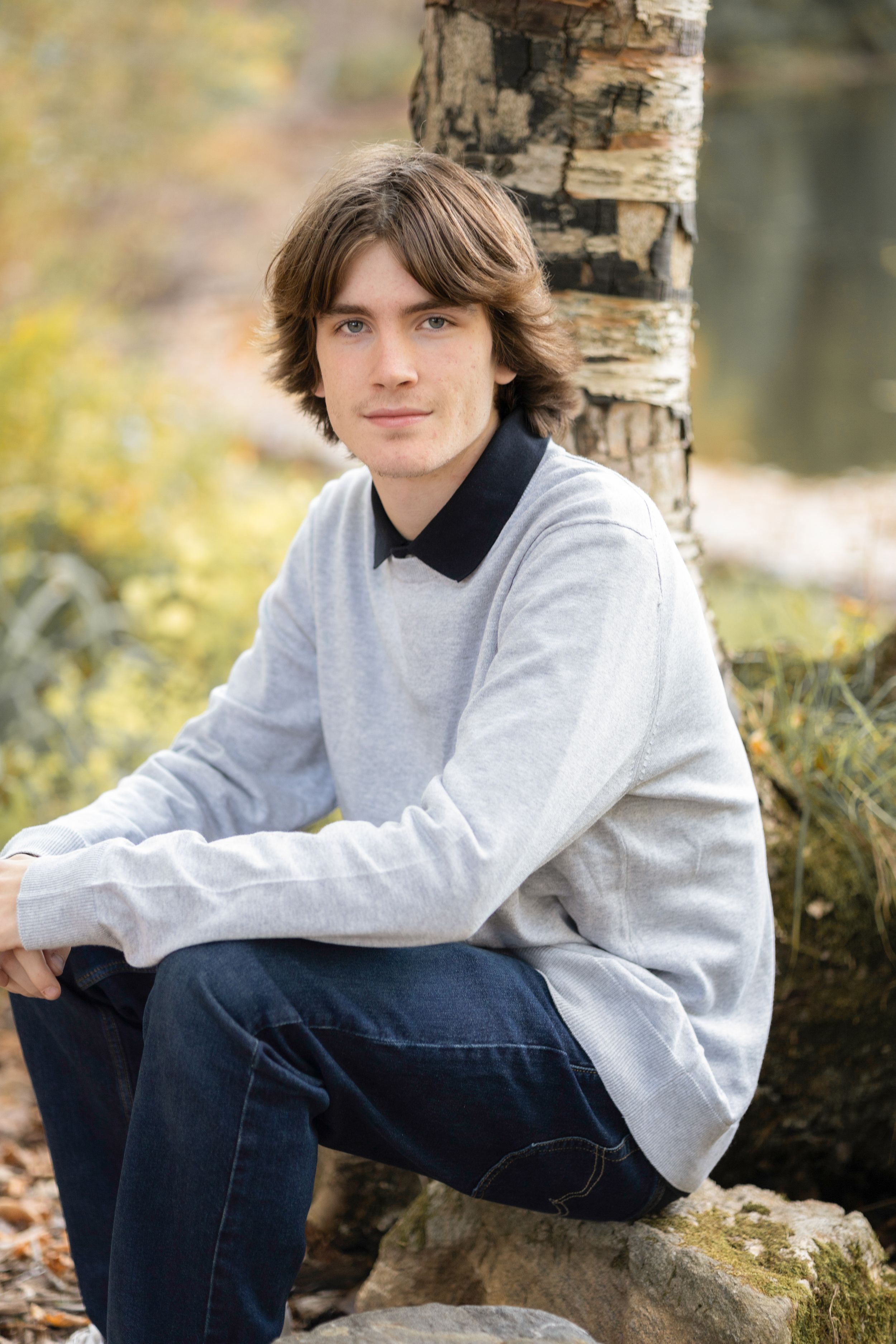 Portrait series in gray sweatshirt against birch tree backdrop.