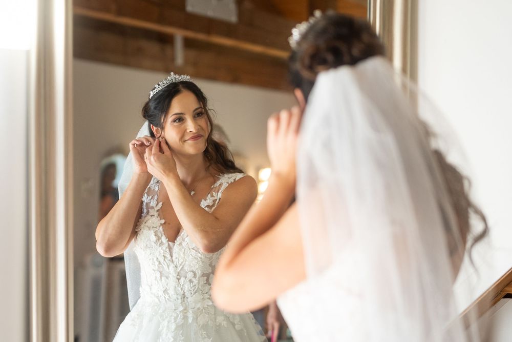 Getting ready wedding photos captured near bright window light.