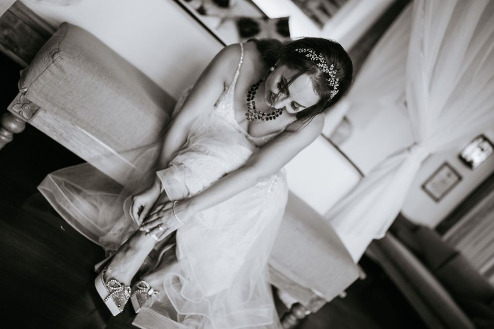 Close-up details of white wedding dress fabric and lace in black and white photography.