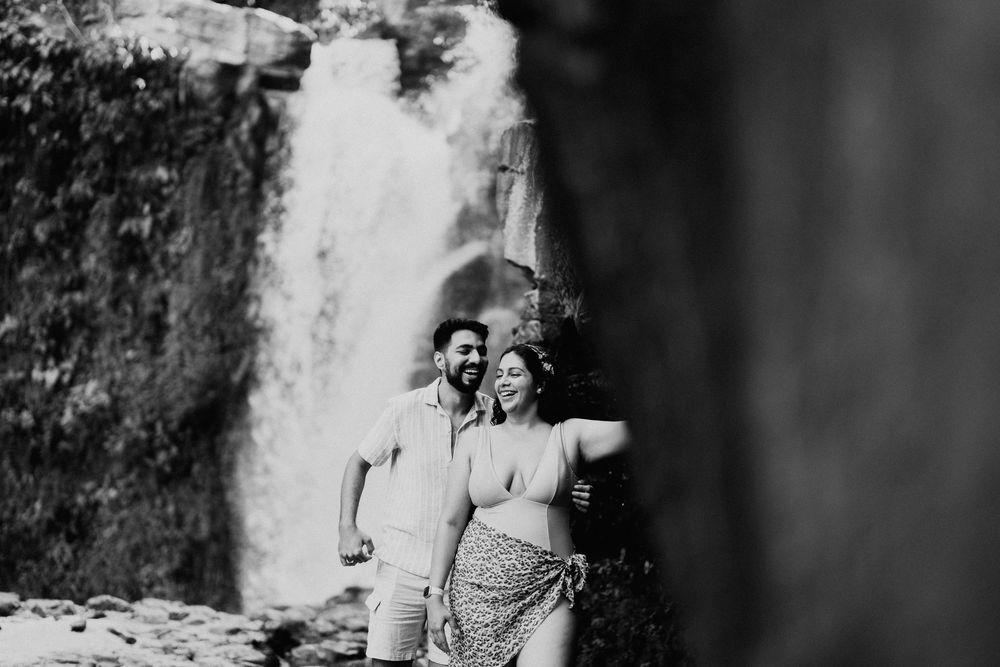 Romantic couple sharing an intimate moment in black and white against a blurred background.