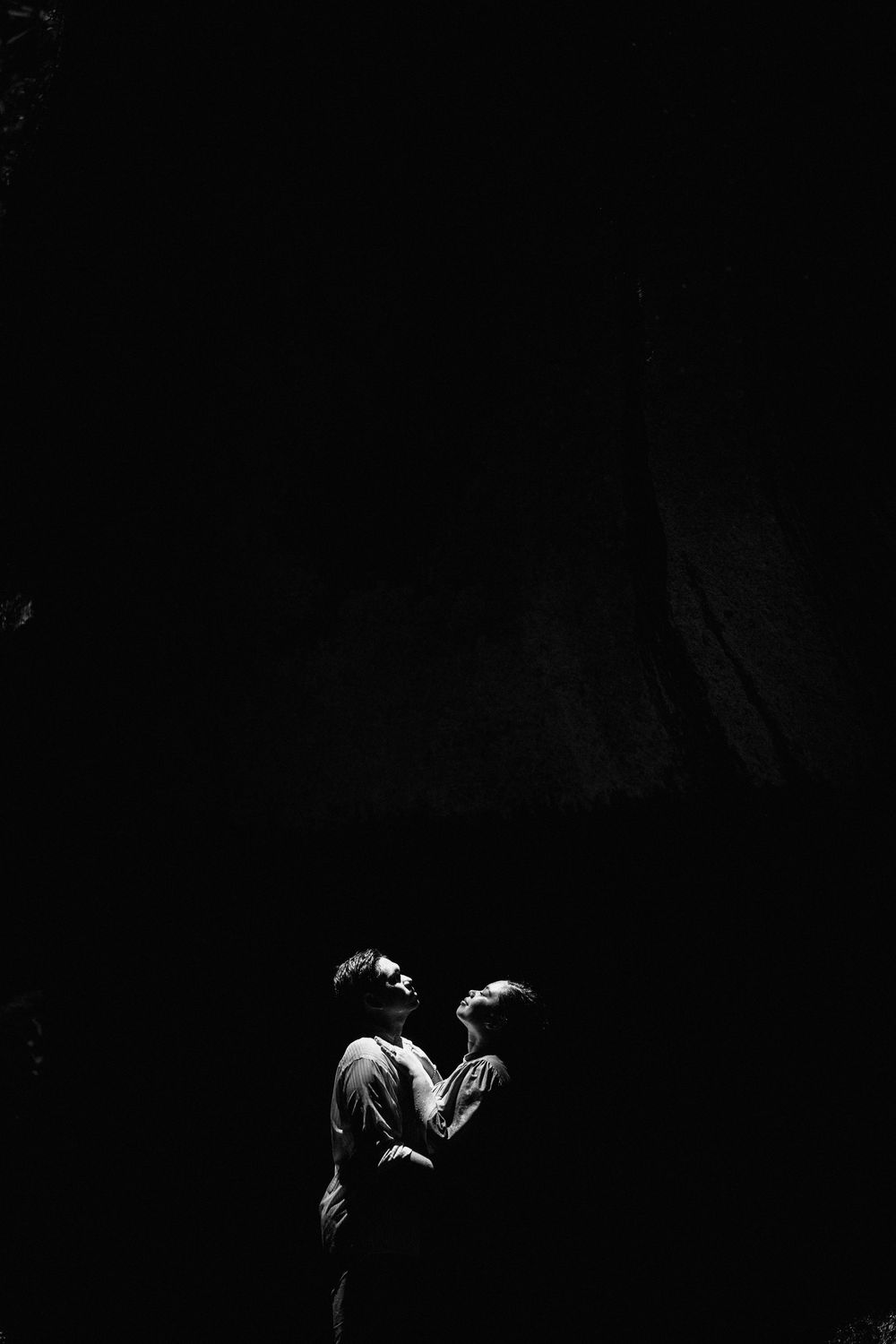 Artistic black and white silhouette of two people in an intimate moment.