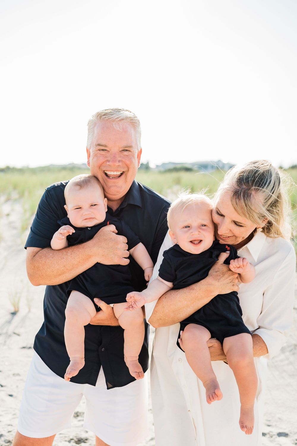 Happy family sharing playful moments together on a sunny beach.