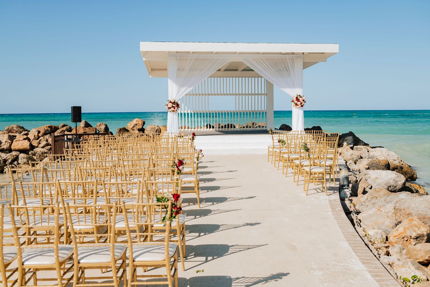A collage of beach wedding ceremony setups with white chairs arranged on sandy shores against turquoise ocean waters.
