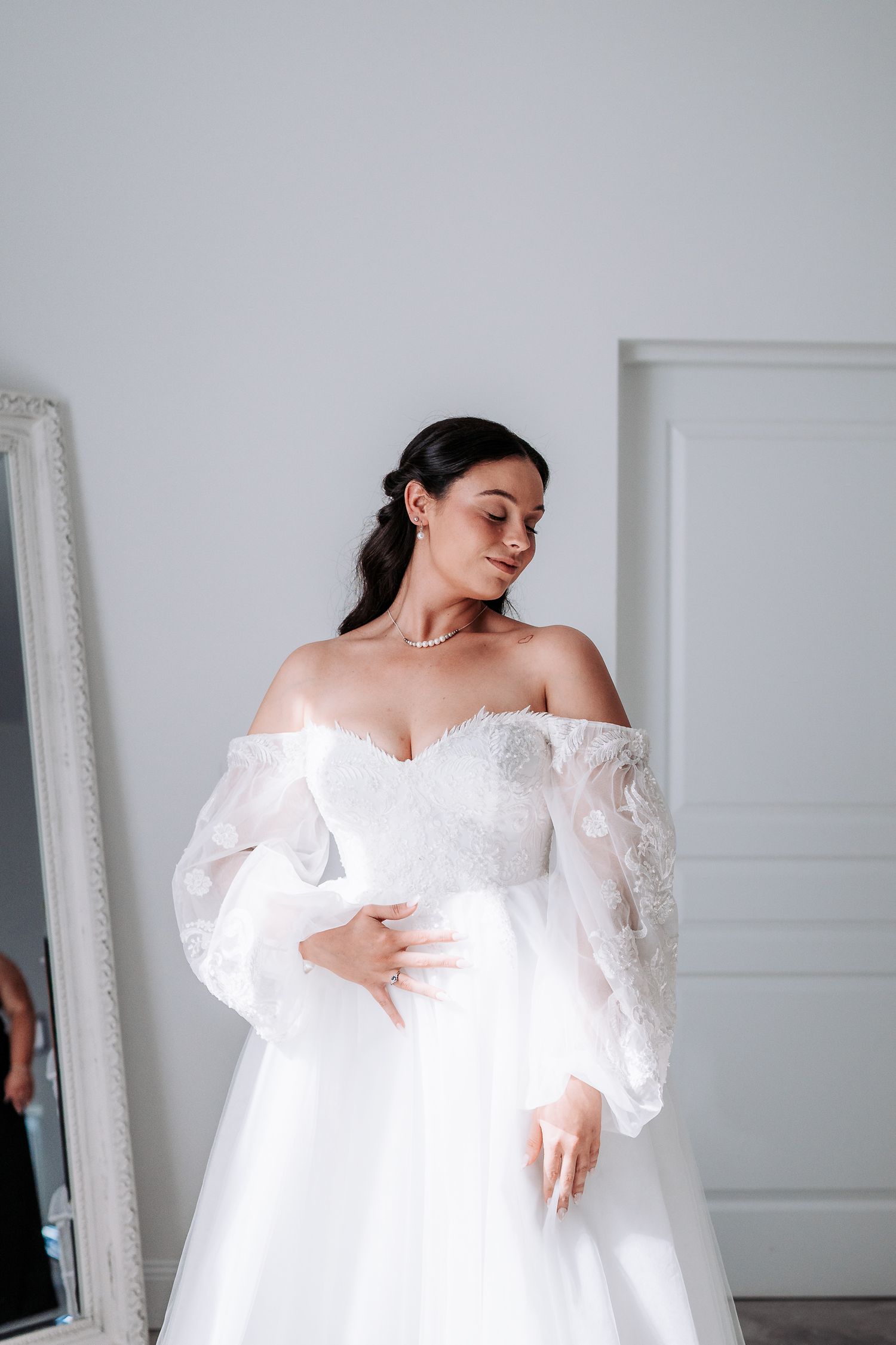 Sequential photos showing close-up details of delicate white lace on an elegant wedding dress.
