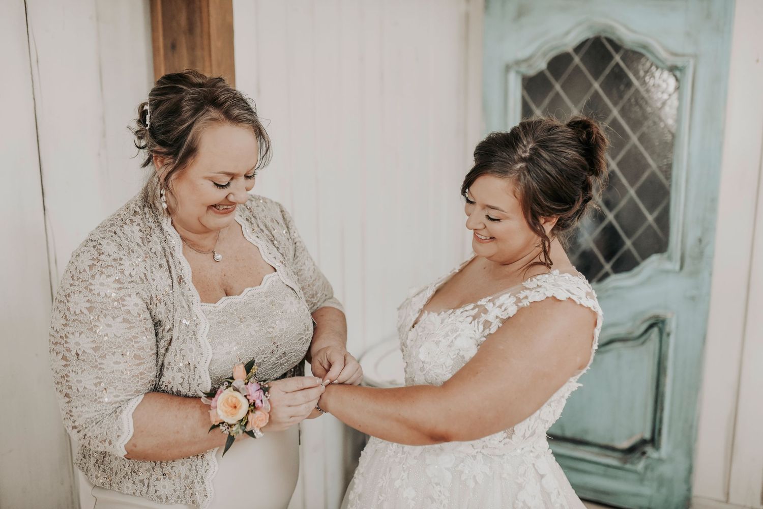 Whispering Oaks bridal suite wedding photography of mother helping bride into gown