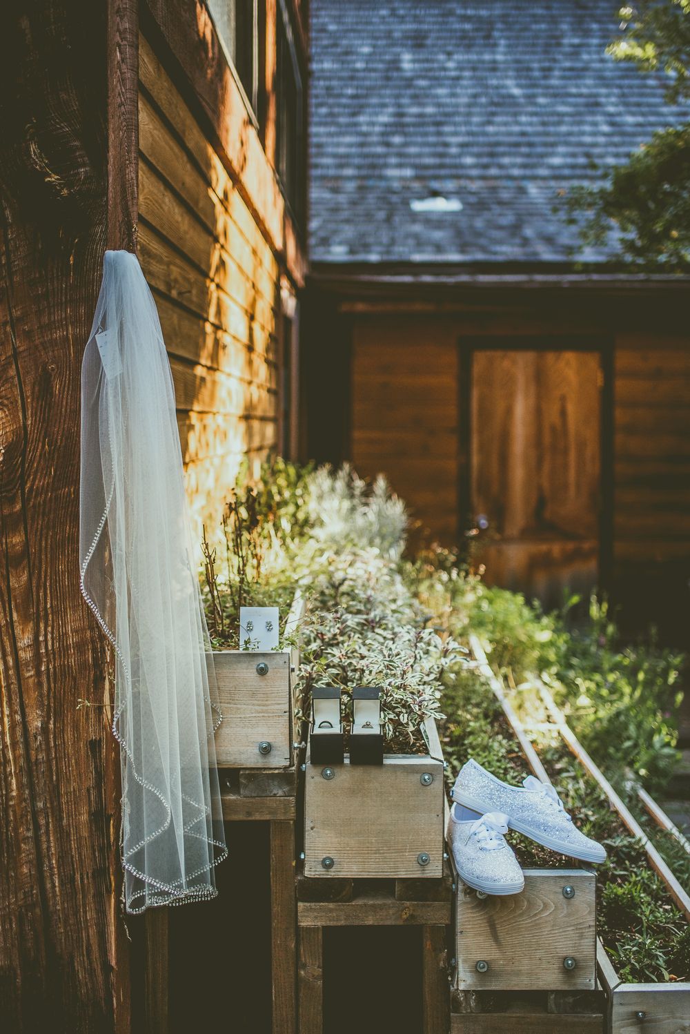 White wedding shoes on a rustic wooden platform decorated with delicate baby's breath flowers. Banff Micro Wedding Photographer