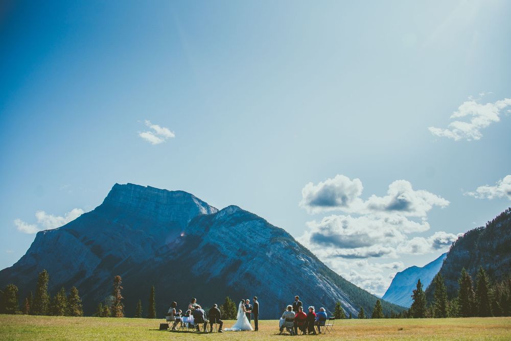 Mountain landscape in Banff National Park with cloudy sky and dramatic peaks in the background. Micro Wedding Photographer