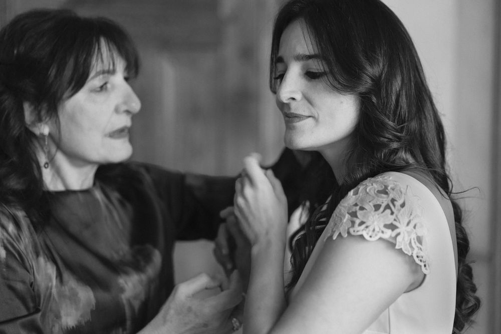 Two people share an intimate black and white portrait moment wearing casual clothing.