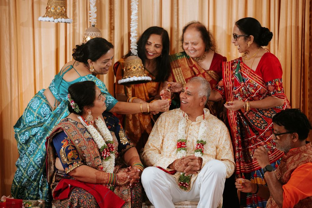 Wedding reception guests share joyful moments and hugs during an intimate celebration with warm lighting.