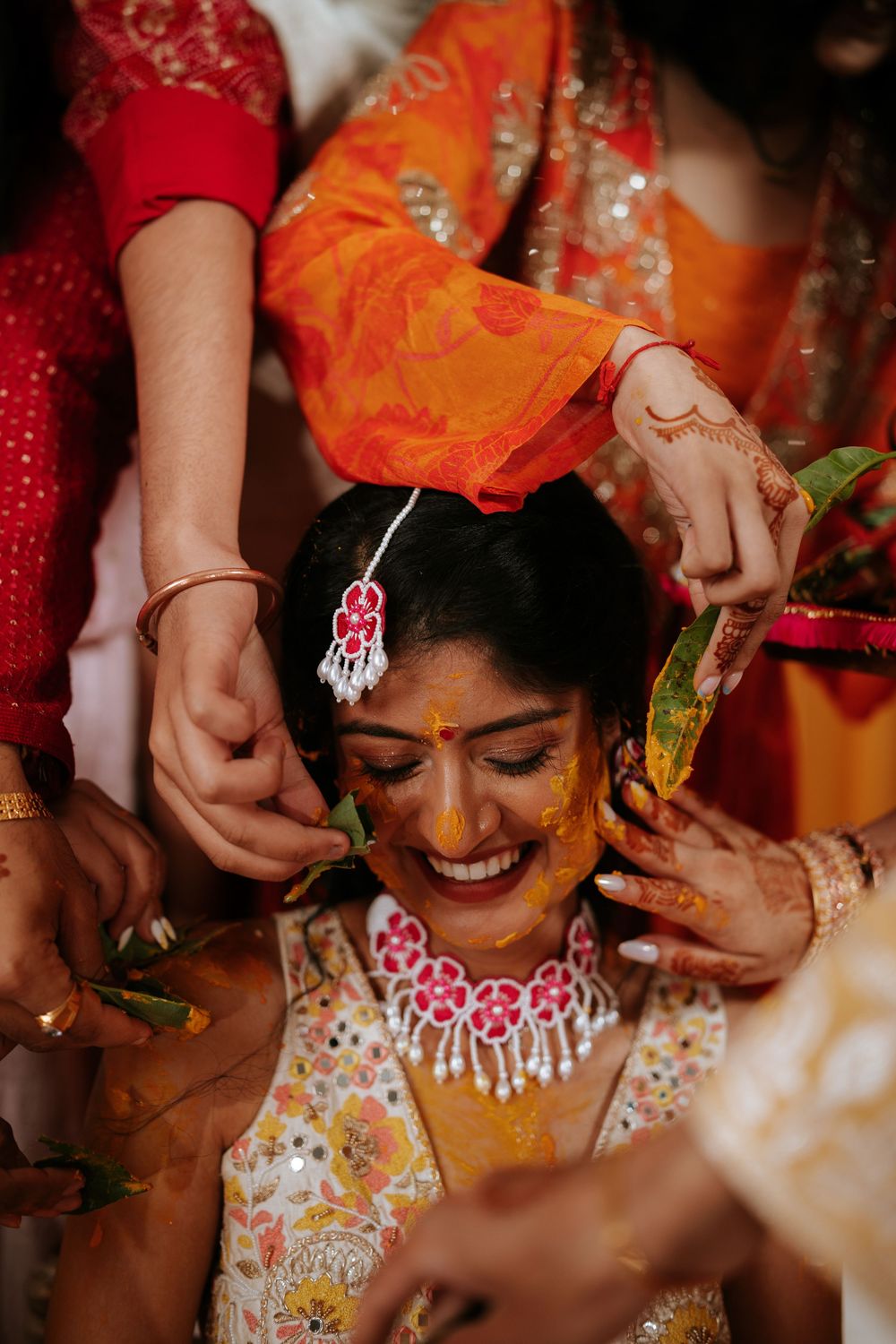 Close-up shots of a bride during traditional Indian wedding preparations with colorful decorations and jewelry.