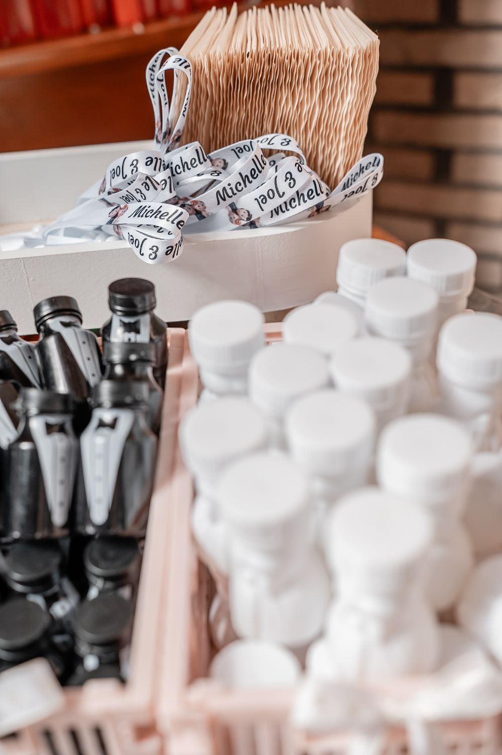 Black and white bubble bottles with decorative ribbons arranged as wedding favors.