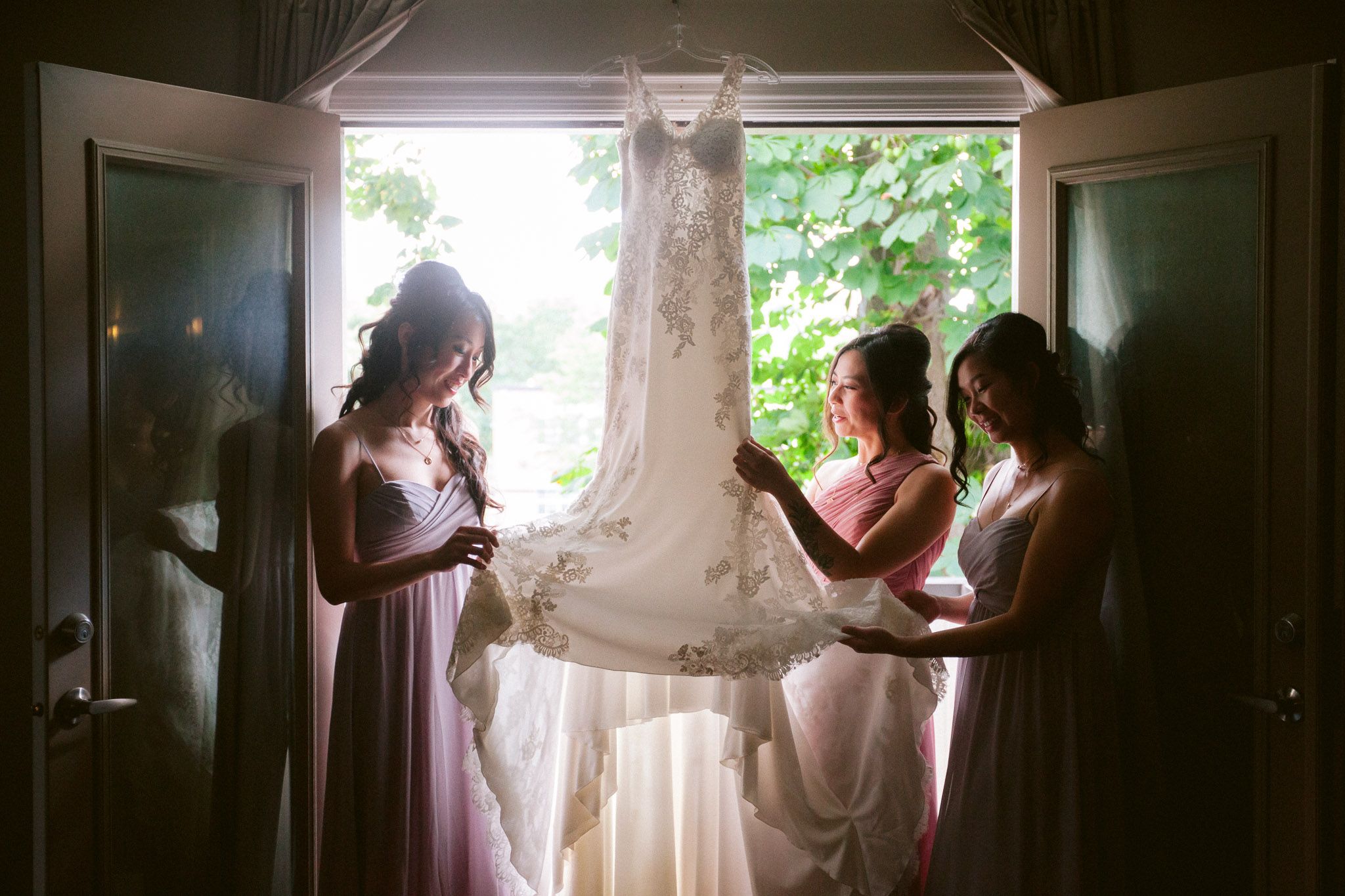 Silhouettes of people preparing by a window with natural light streaming in.
