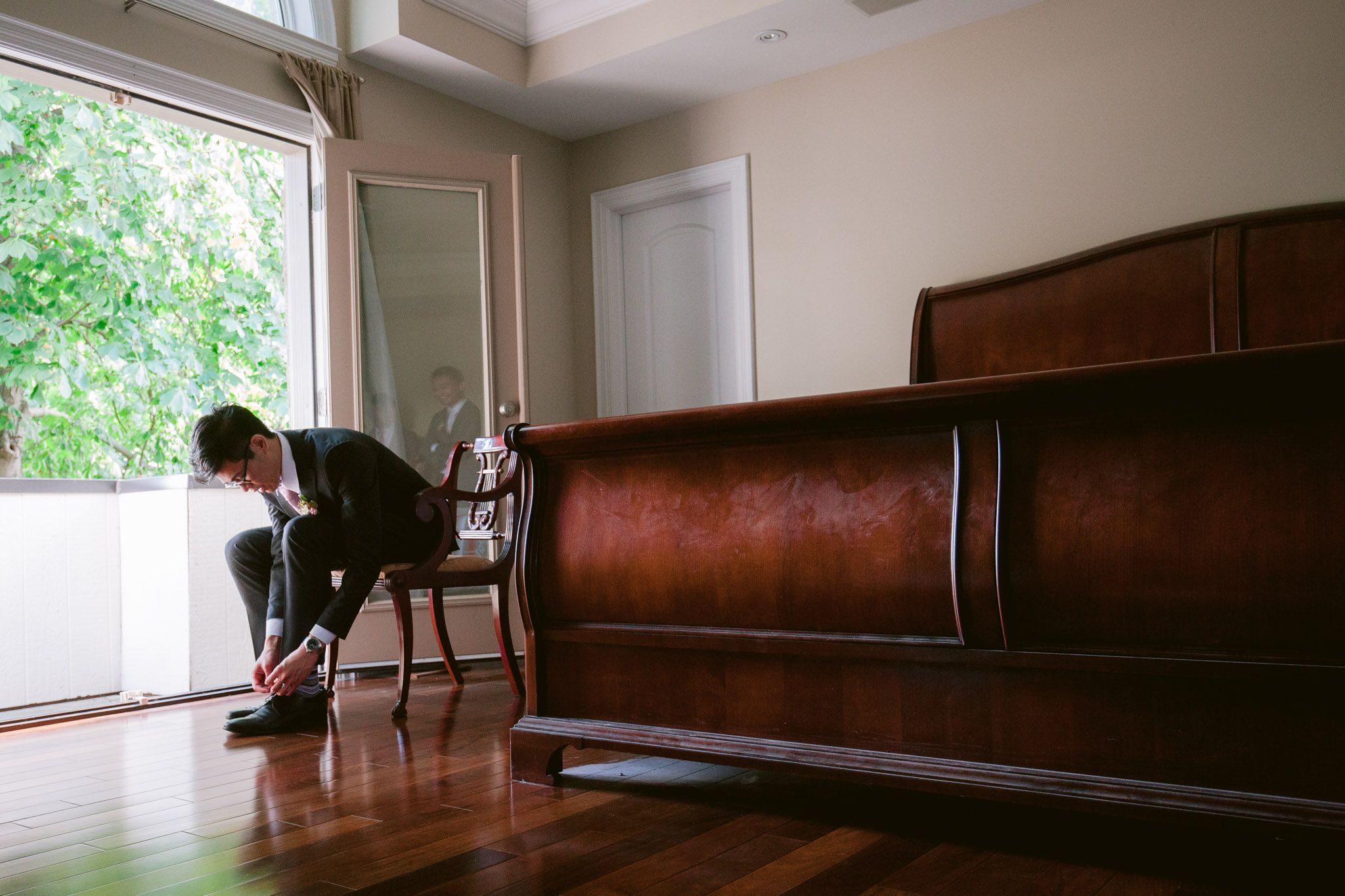 Empty leather benches line a minimalist room with large windows and natural lighting.