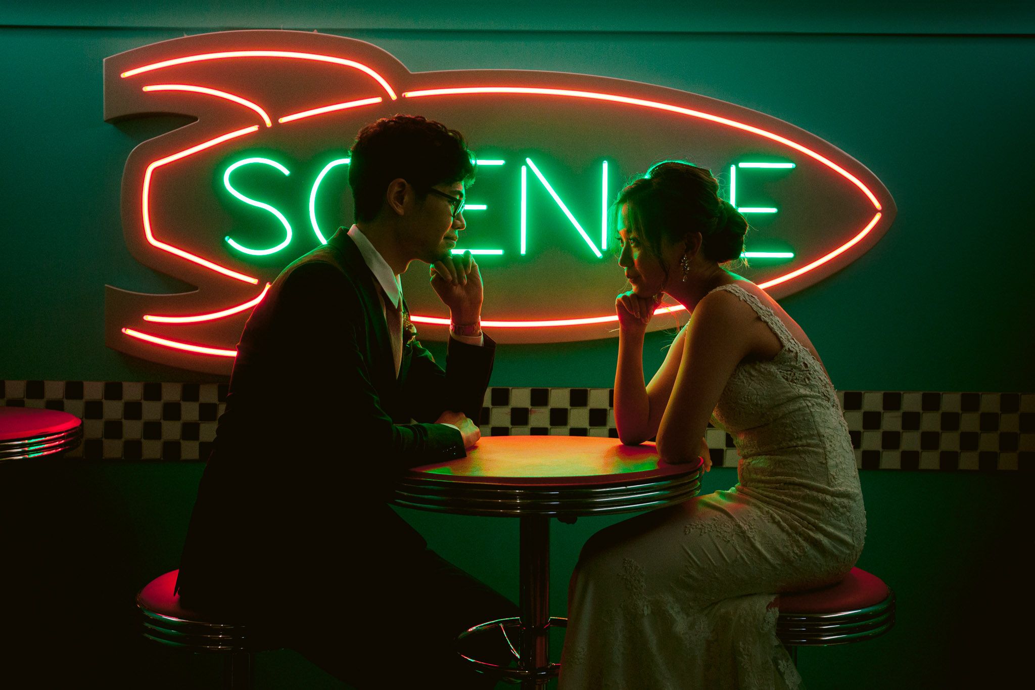 A sequence of dark neon-lit scenes with silhouettes against green and red lighting in what appears to be a bar setting.